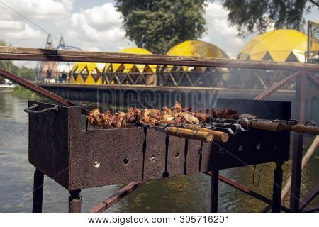 Shashlik Of  Mutton, Beef Or Chicken Meat On The Barbeque Outdoor At The River Side Or Sea Coast