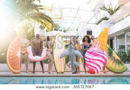 Front View Of Friends At Swimming Pool Party With Lilo Airbed And Swim Wear - Youth Vacation Concept