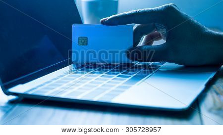 The Concept Of Credit Card Theft. Hackers With Credit Cards On Laptops Use These Data For Unauthoriz