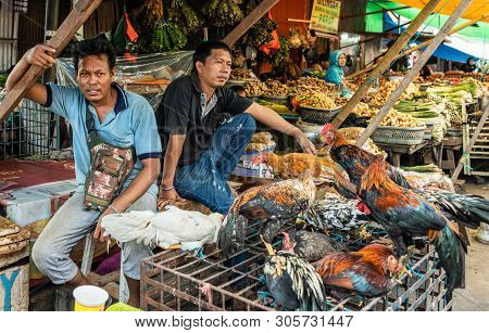 Makassar, Sulawesi, Indonesia - February 28, 2019: Terong Street Market. Two Men Sell Living Chicken