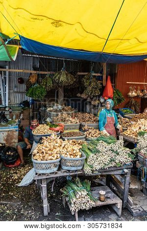 Makassar, Sulawesi, Indonesia - February 28, 2019: Terong Street Market. Woman Sells Variety Of Root