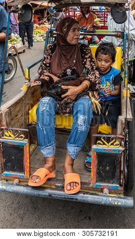 Makassar, Sulawesi, Indonesia - February 28, 2019: Terong Street Market. Closeup Of Grandma And Smal