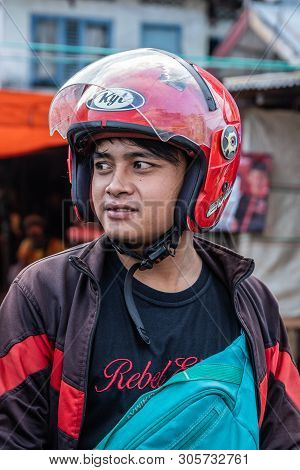 Makassar, Sulawesi, Indonesia - February 28, 2019: Terong Street Market. Closeup Portrait Of Young M