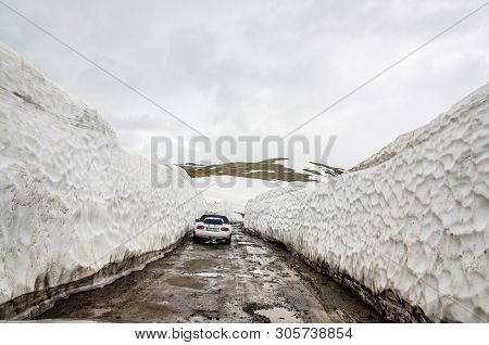 Goderdzi, Georgia - May 8, 2017. Bank Of Snow On Main Broken Dirt Road