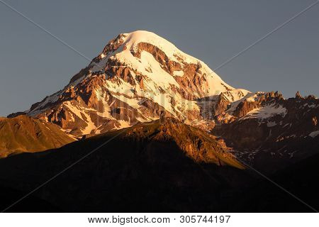 Landscape View Of Mountain Kazbeg On Sunrise, Caucasus Mountains, Country Of Georgia
