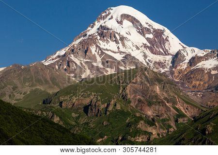 Landscape View Of Mountain Kazbeg On Sunrise, Caucasus Mountains, Country Of Georgia