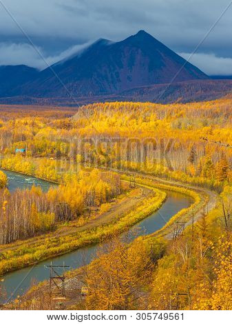 Small River And Canal, Forest In Autumn Colors And Mountains In The Background. Bystrinsky District,