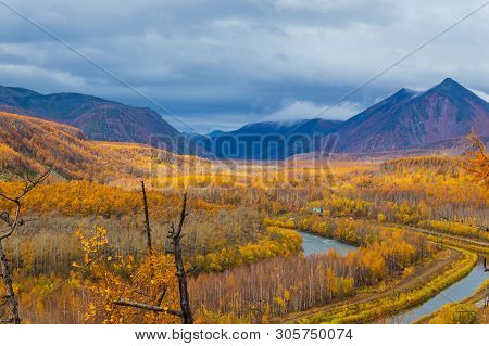 Small River And Canal, Forest In Autumn Colors And Mountains In The Background. Bystrinsky District,