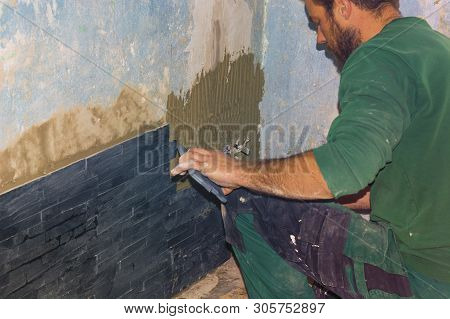 Nice Tiler Sticks Tiles On The Floar