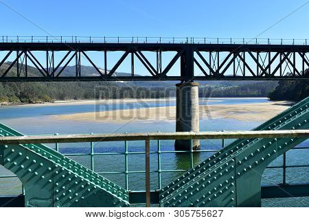Beach With Old And New Train Bridges. O Barqueiro, Spain.