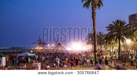 Malaga, Spain - June 23, 2018. Night Scene With Many People At The Malagueta Beach In The Celebratio