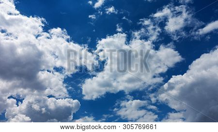 Divine Sky. White Fluffy Clouds In The Blue Sky. Blue Sky Background With Tiny Clouds. Panorama