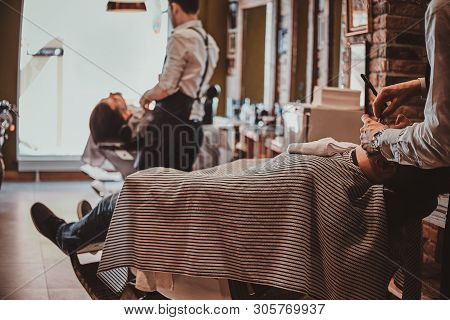 Attractive Relaxed Man Just Got Great Service From Talanted Trendy Barber.