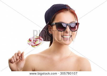 Cool Beautiful Girl With Sunglasses And A Snapback Cap Holding Lollipop, Isolated On A White Backgro