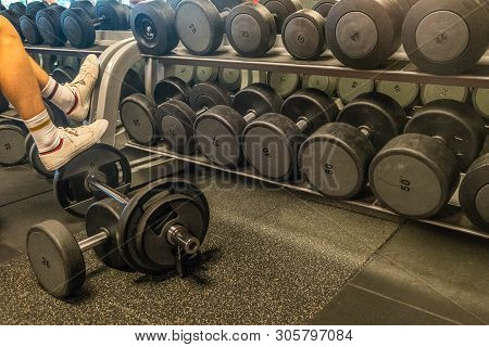 Rows Of Dumbbells In The Gym With Hign Contrast And Monochrome Color Tone.