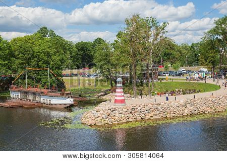 City Jelgava, Latvian Republic. River Lielupe, Peoples And Urban City View. Houses And Walking Paths
