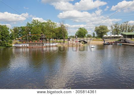 City Jelgava, Latvian Republic. River Lielupe, Peoples And Urban City View. Houses And Walking Paths