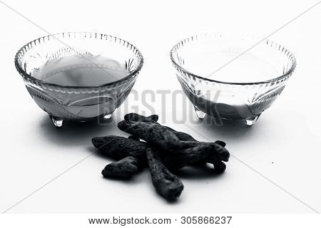 Turmeric & Raw Milk Face Pack Isolated On White In A Glass Bowl Along With Some Raw Milk And Turmeri