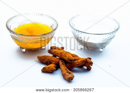 Turmeric & Raw Milk Face Pack Isolated On White In A Glass Bowl Along With Some Raw Milk And Turmeri