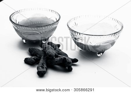 Turmeric & Raw Milk Face Pack Isolated On White In A Glass Bowl Along With Some Raw Milk And Turmeri