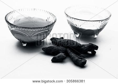 Turmeric & Raw Milk Face Pack Isolated On White In A Glass Bowl Along With Some Raw Milk And Turmeri