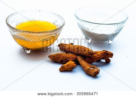 Turmeric & Raw Milk Face Pack Isolated On White In A Glass Bowl Along With Some Raw Milk And Turmeri