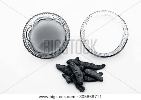 Turmeric & Raw Milk Face Pack Isolated On White In A Glass Bowl Along With Some Raw Milk And Turmeri