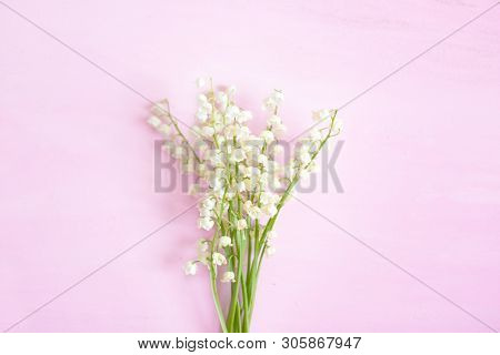 Wonderful Fragrant White Flowers With A Delicate Scent. Lilly Of The Valley Flowers On A Pink Wooden