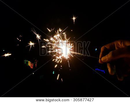 Burning Of Hand Held Sparkle Firework In Black Background