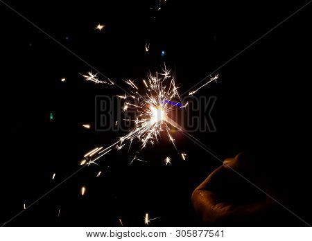 Burning Of Hand Held Sparkle Firework In Black Background