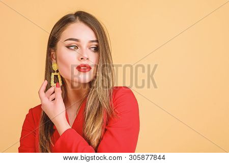 Jewelry Shop. Girl Model Long Hair Demonstrating Golden Jewelry Earrings. Expensive Accessory. Fashi