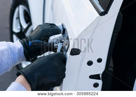 The Thief Broke The Lock On The Door Of The White Car And Opened It, Close-up