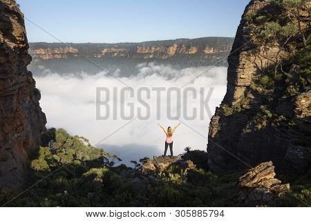 Female Hiker Feelings Of Exhilaration And Awe Stainding On A Rocky Precipice In A Narrow Gully Of Sh