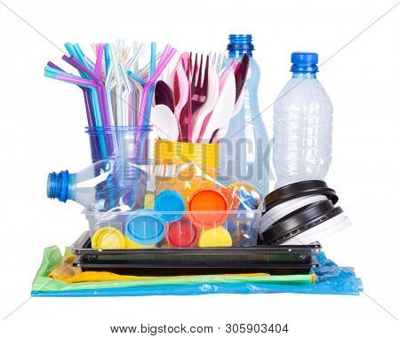 Disposable single use plastic objects such as bottles, cups, forks, spoons and drinking straws that cause pollution of the environment, especially oceans. Isolated on white background.