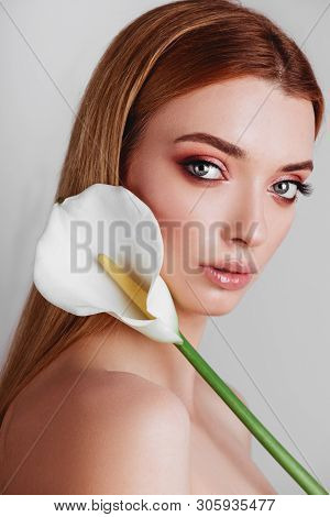 Portrait Of Happy Young Redhead Lady Looking Out Of White Flowers Studio Shot