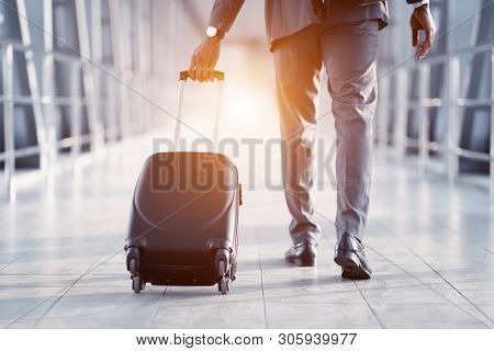 Businessman Carrying Suitcase, Walking Through Passenger Boarding Bridge, Back View