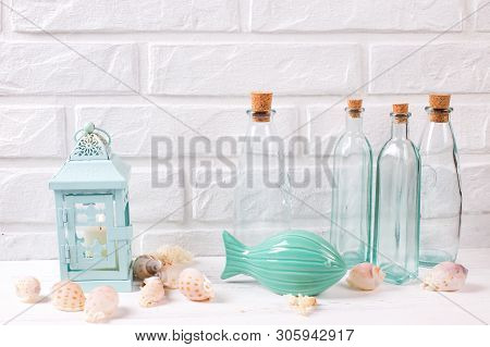 Seaside  Summer Living Decorations Near By White Brick Wall. Decorative Fish, Candle Holder With Bur
