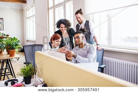 Group Of Young Businesspeople Working In Office, Start-up Concept.