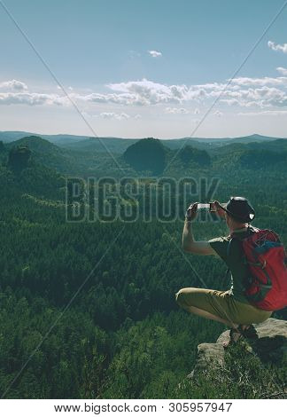 Phone Photographer. Man Tourist On The Edge Take Phone Pictures.  Hker In Leather Hat, T-shirt, Shor