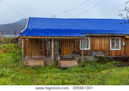 Esso, Kamchatka Peninsula, Russia- 02 October 2014: Wooden, Small House With Blue Roof And Porch. Mo