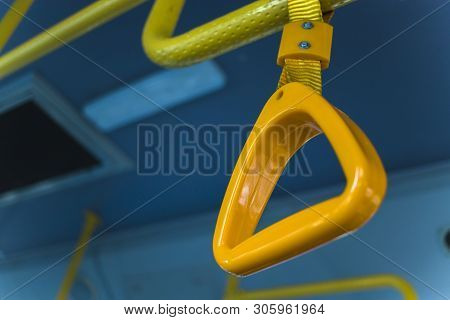 Yellow  Hanging Handhold For Standing Passengers In A Modern Bus. Suburban And Urban Transport