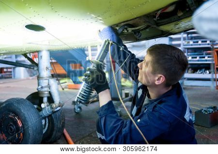Tyumen, Russia - June 5, 2019: Aircraft Repair Helicopter Utair Engineering Plant. Worker Maintainin