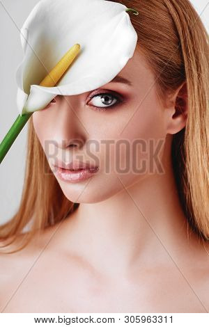 Portrait Of Happy Young Redhead Lady Looking Out Of White Flowers Studio Shot