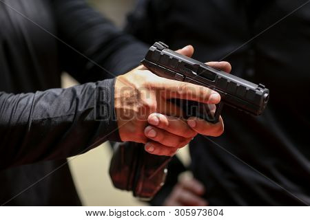 Bucharest, Romania - June 10, 2019: Details With The Hands Of A Soldier Handling A 9mm Caliber Beret