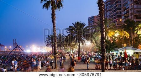 Malaga, Spain - June 23, 2018. Night Scene With Many People At The Malagueta Beach In The Celebratio