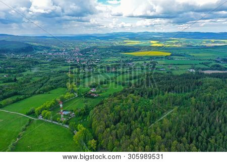 Aerial Perspective View On Sudety Mountains With Touristic City In The Valley Surrounded By Meadows,