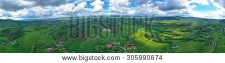 Aerial Wide Panoramic View On Sudety Mountains With Touristic City In The Valley Surrounded By Meado