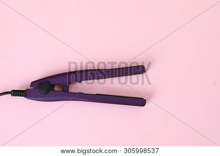 Modern Hair Iron For Straightening On Color Background, Top View