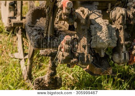 Close Up Of Mechanical Fingers Of Rice Planting Machine Caked With Mud.
