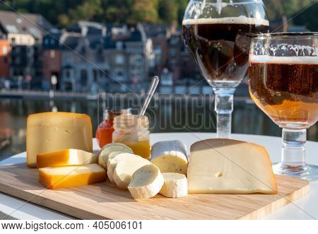 Glass Of Belgian Abbey Beer And Tasting Of Cheeses Made With Trappist Beer And Fine Herbs With View